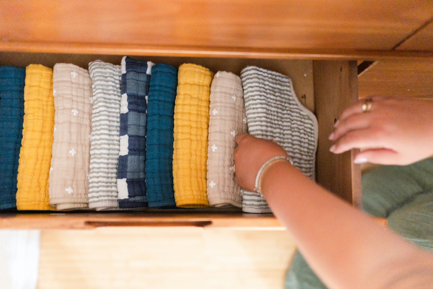 View of a drawer with neatly folded clothes inside.